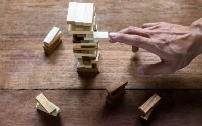 planning risk and strategy in business businessman and engineer gambling placing wooden block on tower min